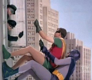 Batman and Robin climbing up a building